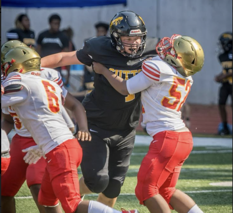 Freshman football player Javier Rivera battling a former opponent
