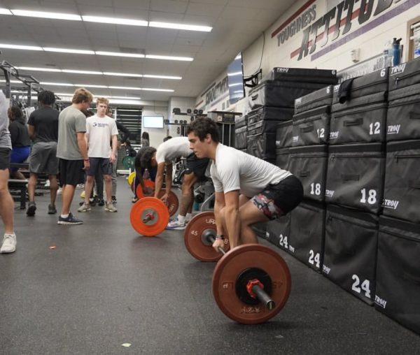 Muscle and Motivation: Dubs football players push limits in the weight room.
