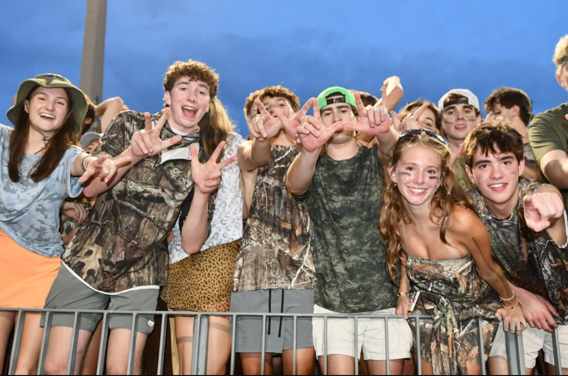 The North Atlanta student section supporting the football team in full camouflage.