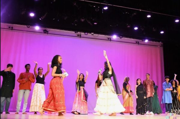 Performers enter the stage after the end of the performance, celebrating their successful show.