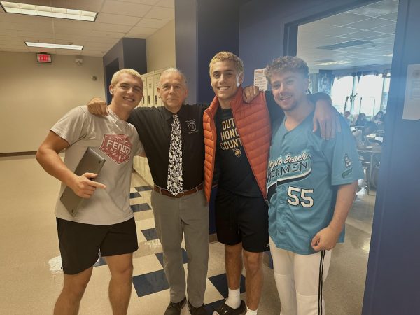 Living Legend: French teacher Phillipe Maury surrounded by some of his favorite students.
