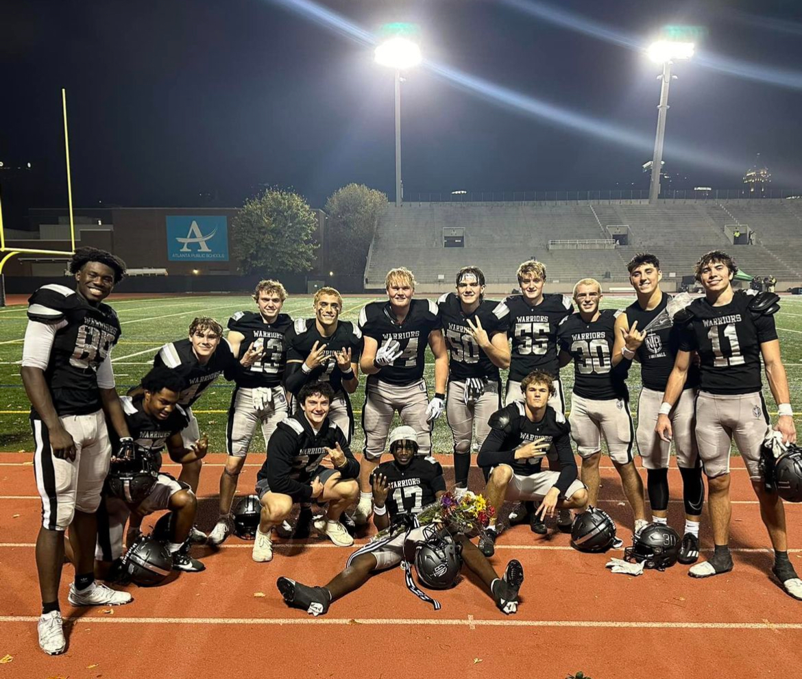 The warrior football team after winning their first region title in program history
