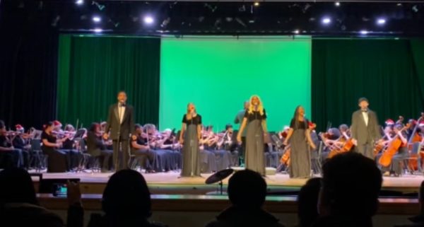 Orchestra and Chorus singing “Please Come Home for Christmas.”
