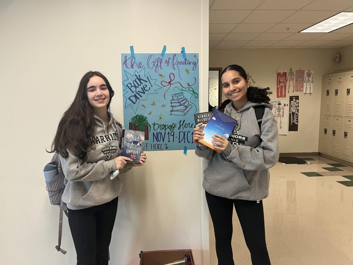 ‘’Tis the Gift of Reading!’ Sophomores Lily Floyd and Maryam Hashim spread the goodwill!”