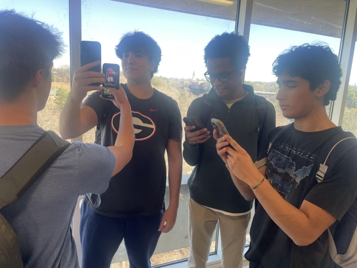 Doomscrolling stops at nothing, not even in the hallways of NAHS: North Atlanta students scroll through their favorite social media apps.