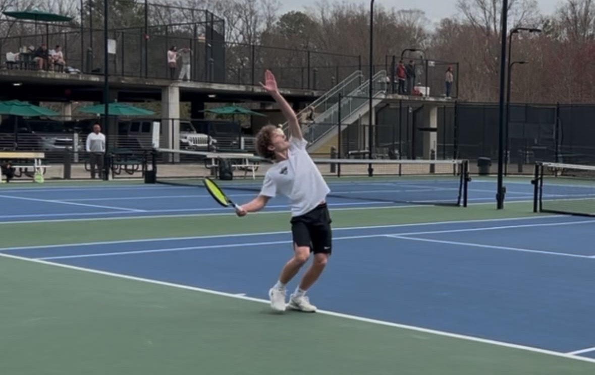 Bauer loads up for a booming serve