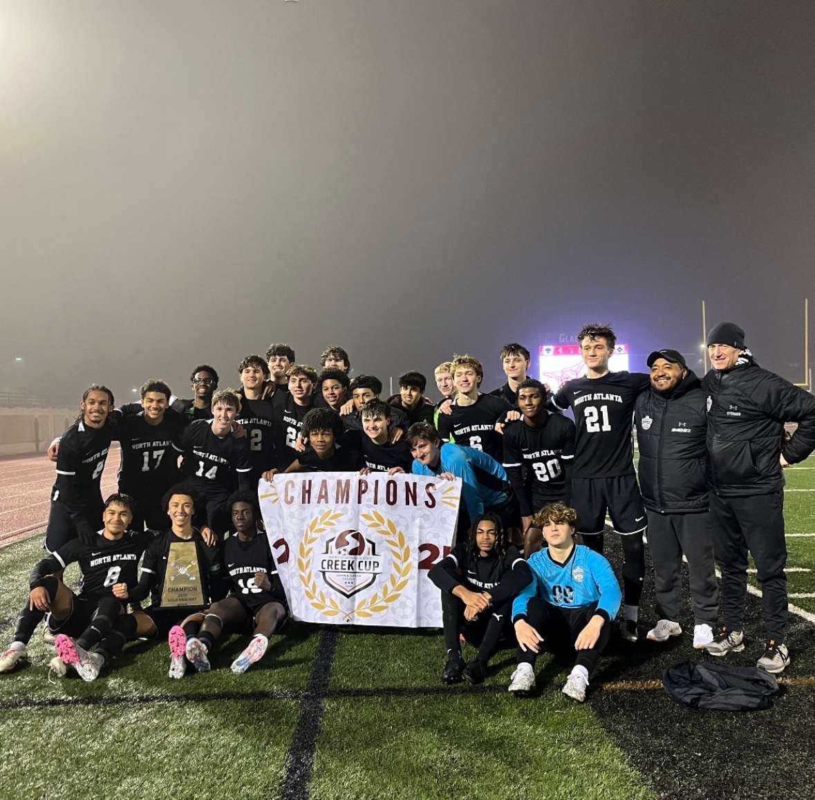 North Atlanta varsity soccer raises trophy in Creek Cup.
