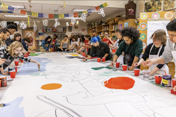 National Art Honors Society ambassadors bring in students to begin painting the Legacy Mural.