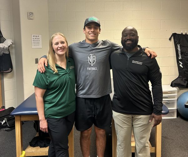 Trainers Andrea Davis (left) and Demetre Ledlum (right) with football and track athlete Josh McCullough (middle)